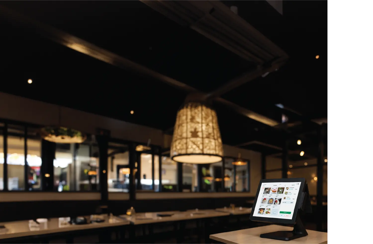 Premium restaurant interior with AigentPOS terminal on the counter